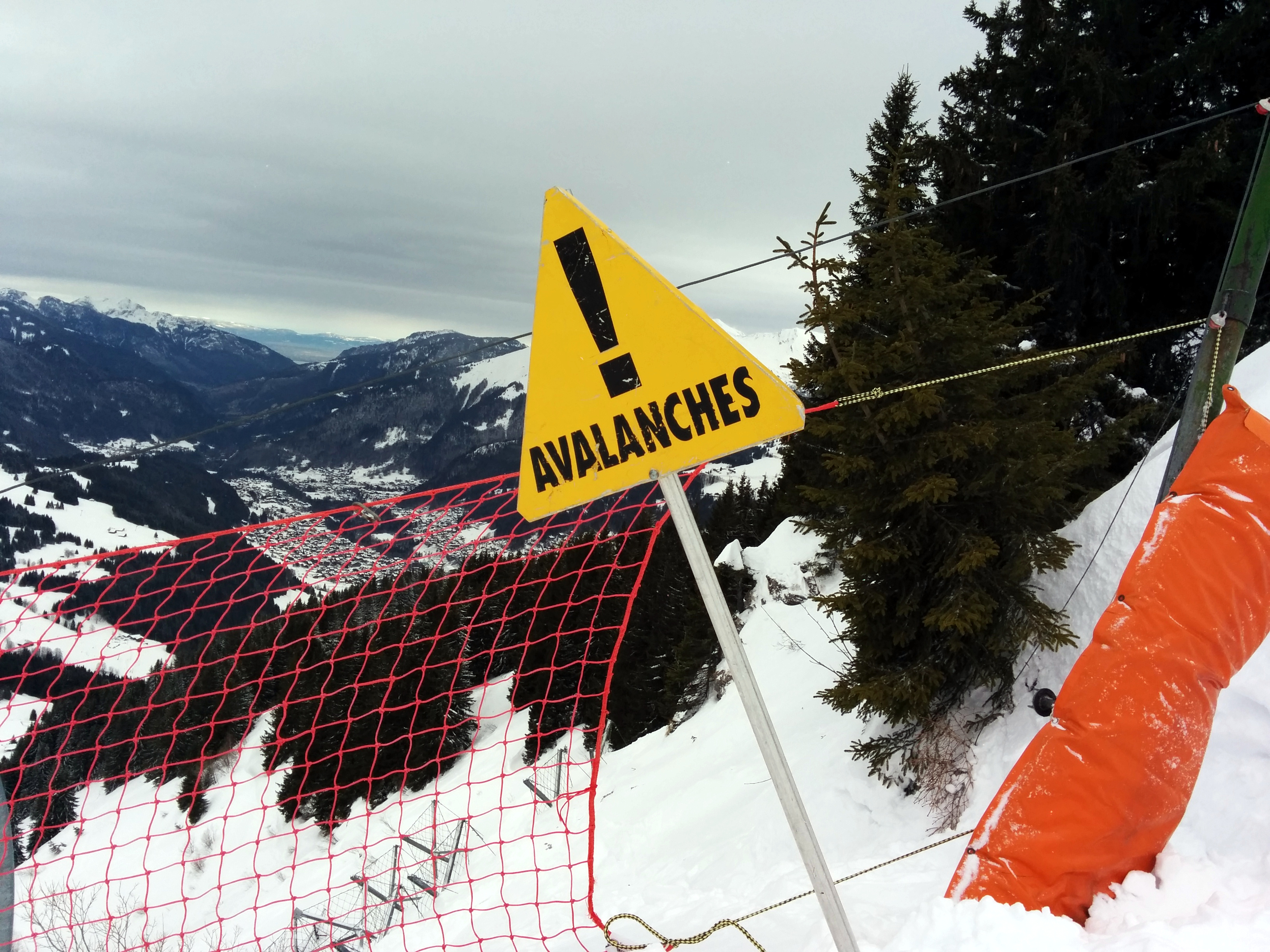 Avalanche Quiz - Avalanche Warning Sign on a Snowy Mountain image